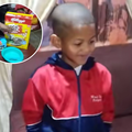 A young boy wearing a tracksuit smiles