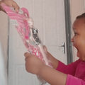 A young child expresses excitement over a gift