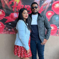 A young couple from KZN stand in front of a birthday sign