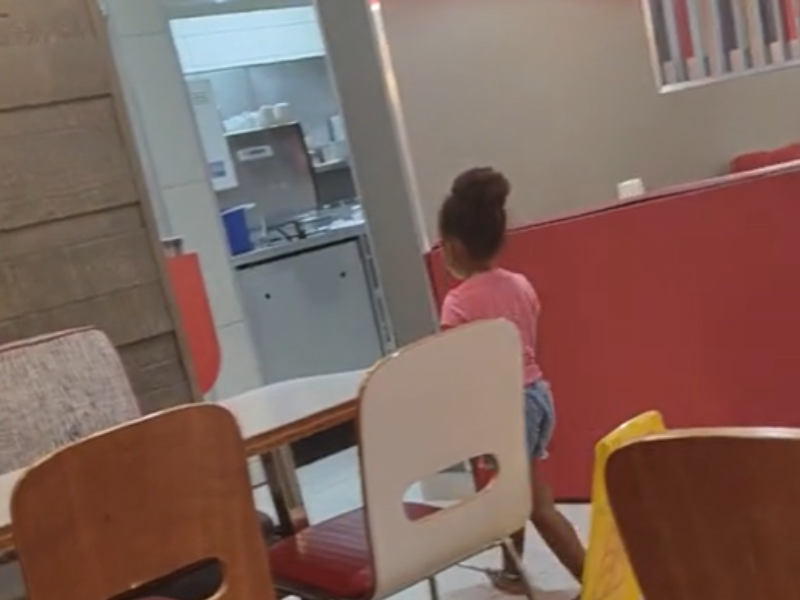 A young girl walks to the kitchen at a Wimpy restuarant