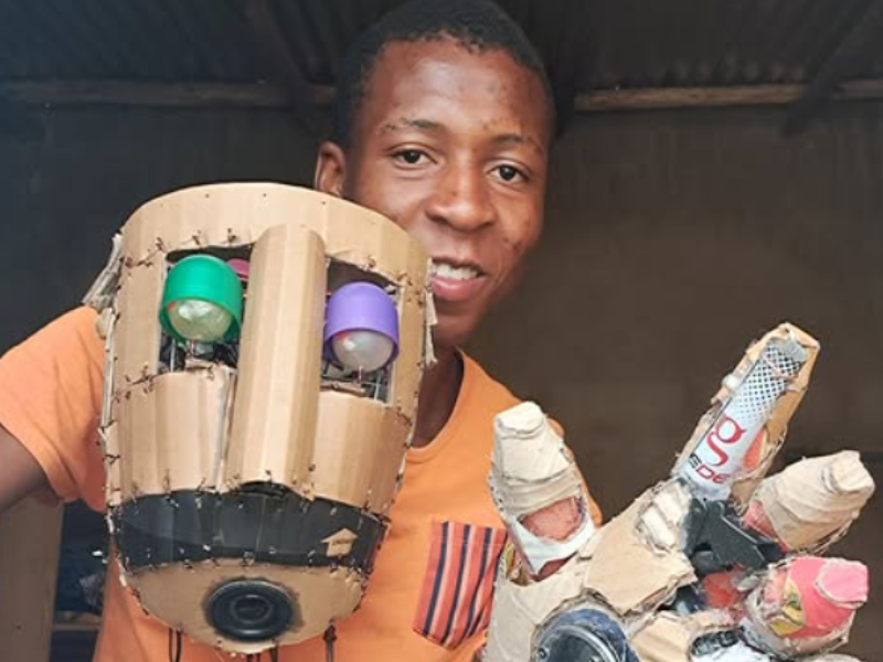 A young man shows off his homemade robot