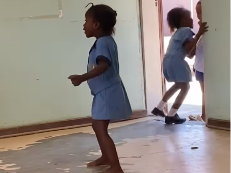 A young school girl dancing inside the teachers staff room