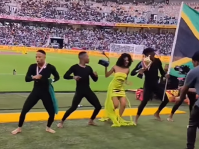 A young woman dressed like Tyla dancing with other dancers at the Moses Mabhida stadium
