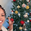 A young woman points to the Christmas tree