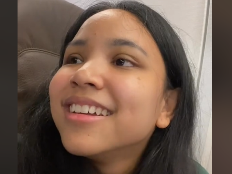 A young woman sitting inside an airplane