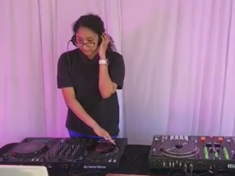 A young woman with glasses at a turntable