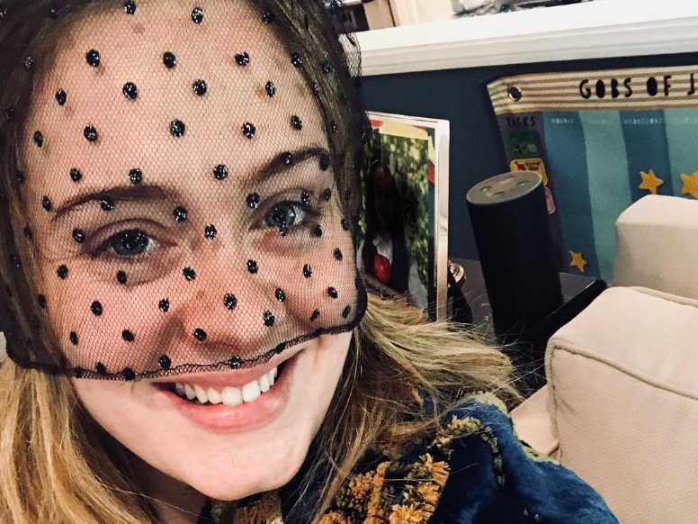 Adele wearing black hat