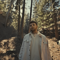 Alex Warren walks through a forest