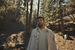 Alex Warren walks through a forest