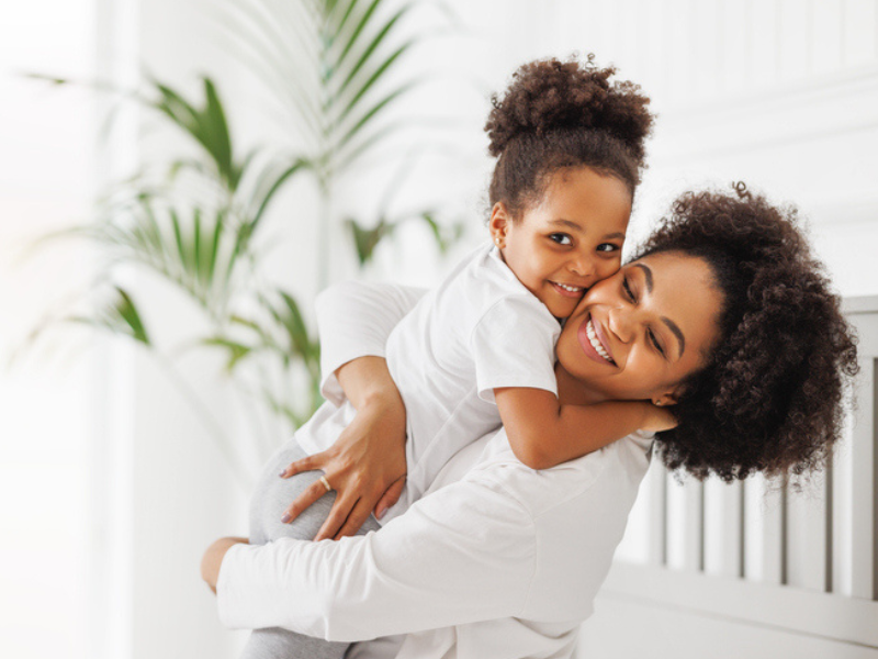 An African mother hugs her daughter