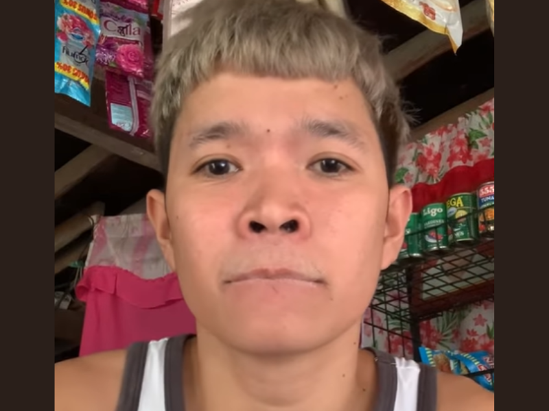 An Asian man glues his lips stuck