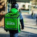 An Uber Eats delivery person carrying food to people
