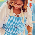 An artist wearing an apron at a painting class