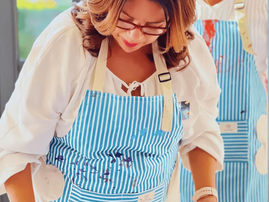An artist wearing an apron at a painting class