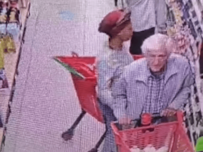 An elderly man gets distracted by a woman trying to grab his car keys