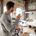 An office worker waves goodbye to his colleagues