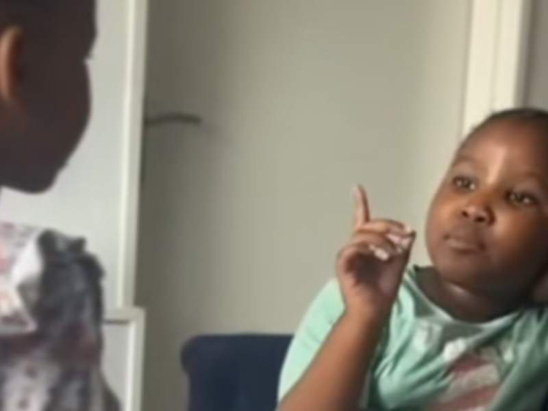 An older sister wags her finger in her younger sisters face