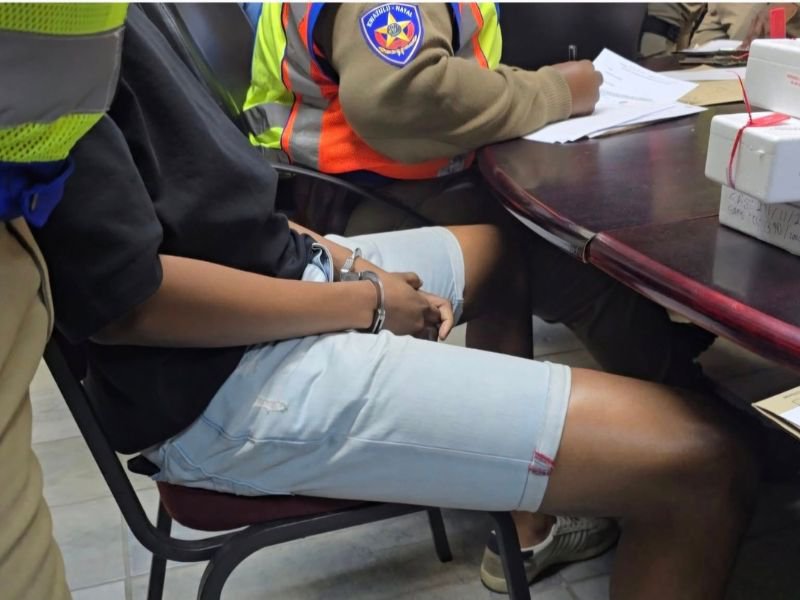 Person sitting with handcuffs