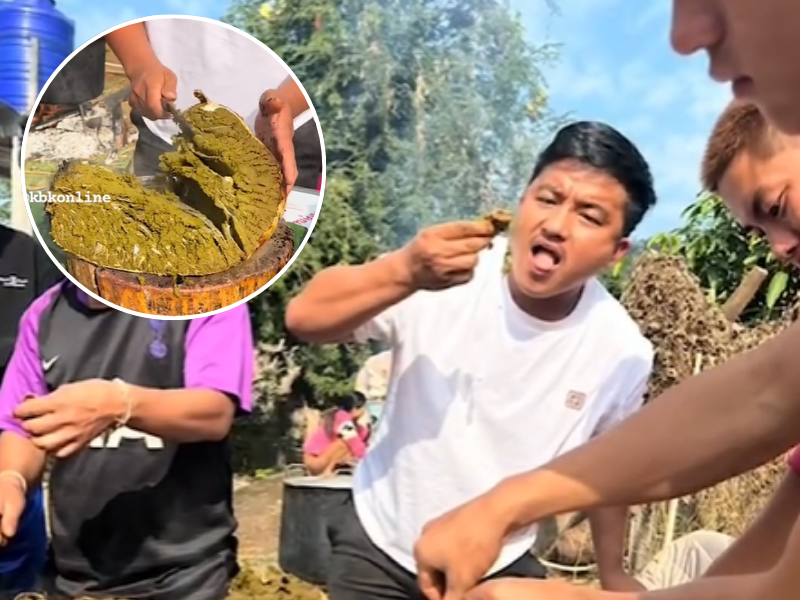 Asian men eating something they prepared outside