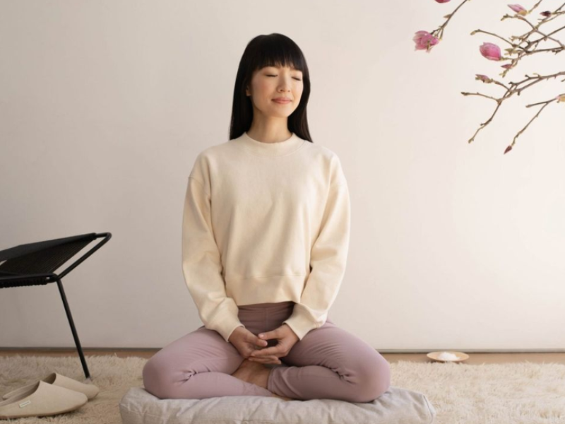 Asian woman sitting on a pillow and meditating