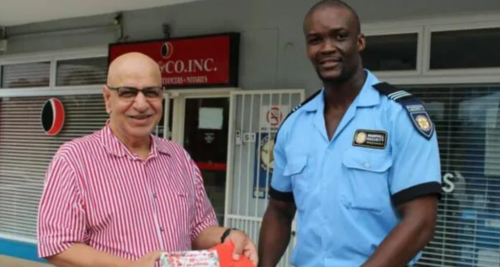 Durban attorney Umesh Jivan hands a gift to security officer