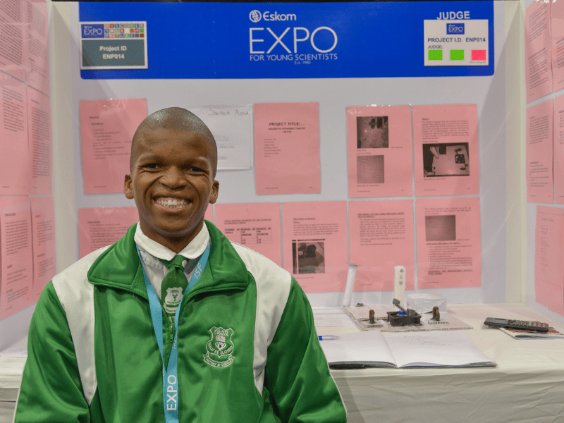 Azola Sihlahla stands at his booth at the Eskom science fair