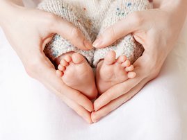 Baby feet in mother hand