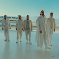 The Backstreet Boys pose inside an airplane hanger