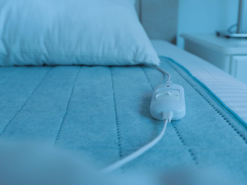 Bed with electric heating pad