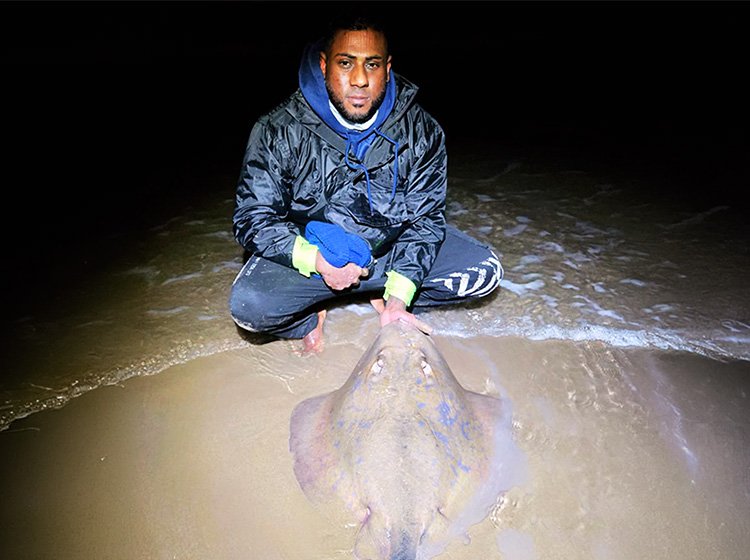 Benedict Pillay with a blue ray caught down South Coast