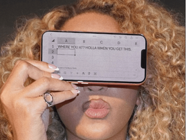 Beyonce covers her eyes with an iPhone
