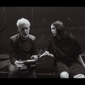 Titanic director James Cameron and Billie Eilish sitting on a stage