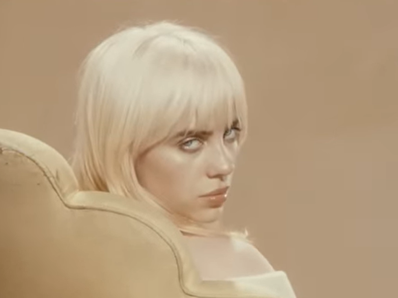 Billie Eilish sitting on a chair