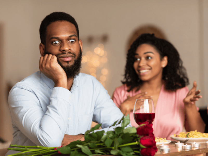 Black man on an unsuccessful first date at a restaurant with a woman