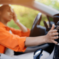 Black woman in car stressed by the heat