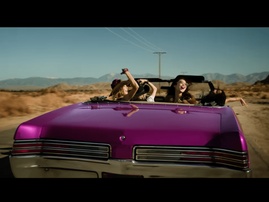 Blackpink members in a pink convertible