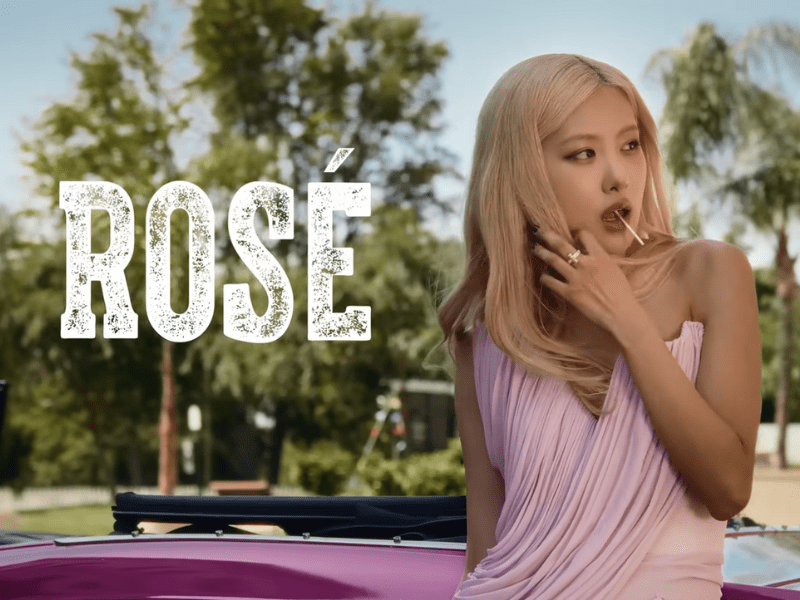 Blackpink star Rose wears a pink dress while posing outdoors