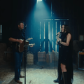 Blake Shelton and Noah Cyrus singing in a barn