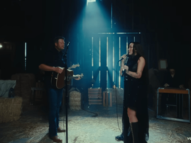 Blake Shelton and Noah Cyrus singing in a barn