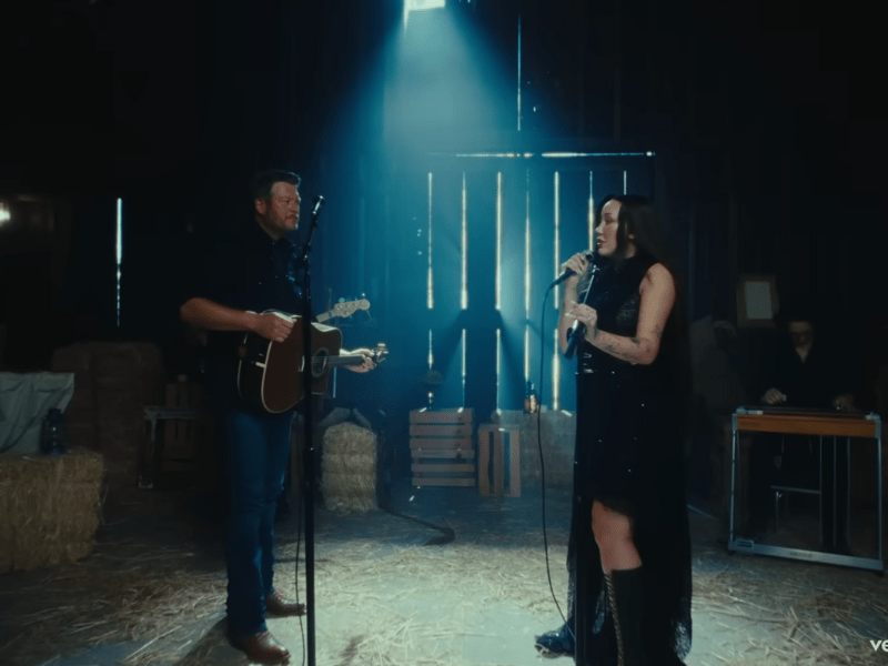 Blake Shelton and Noah Cyrus singing in a barn