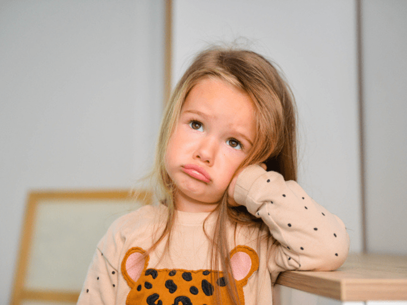 Upset blonde girl pouts