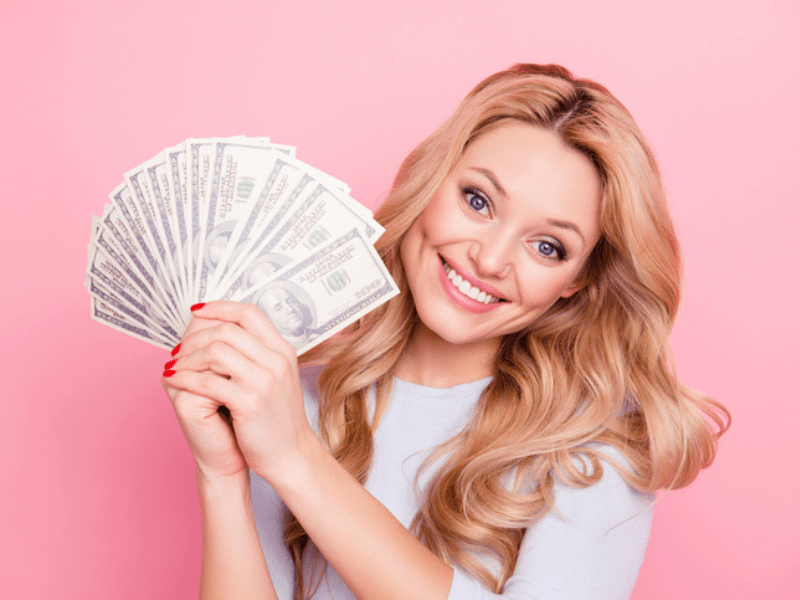 Blonde woman holding a fan of money