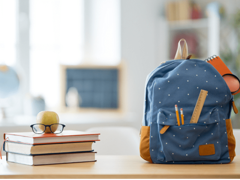 Blue and brown bag on a school desk