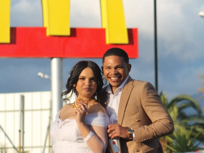 Bridal couple standing in front of a McDonalds