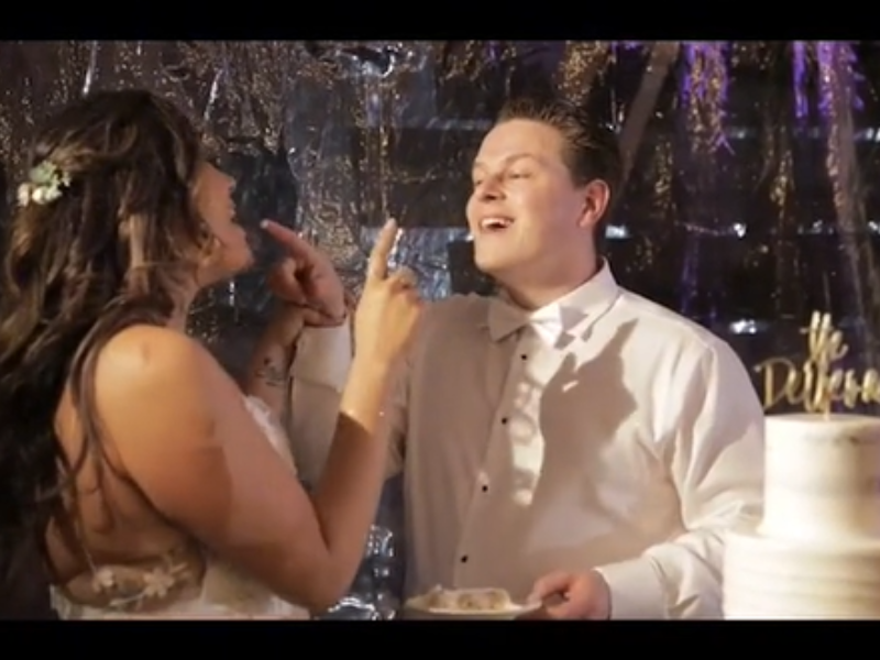 Bride and groom feeding each other wedding cake