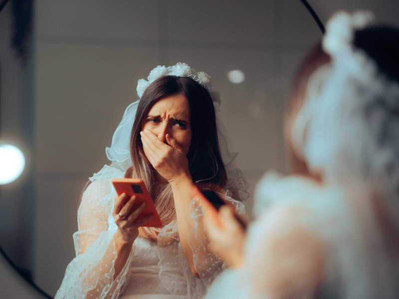 Bride crying while holding a phone
