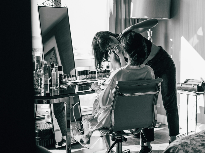 Bride getting her makeup done at home
