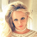 Britney Spears wearing a white choker and white lace top
