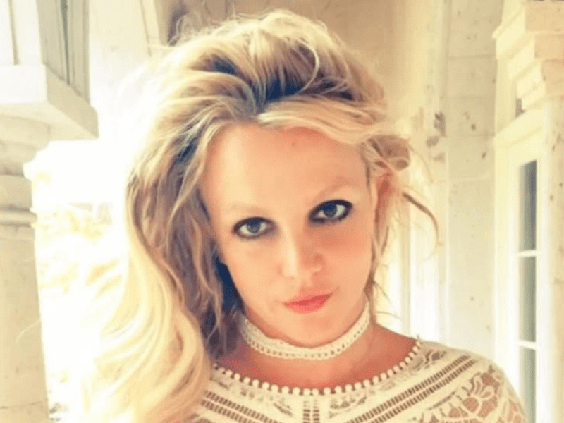 Britney Spears wearing a white choker and white lace top