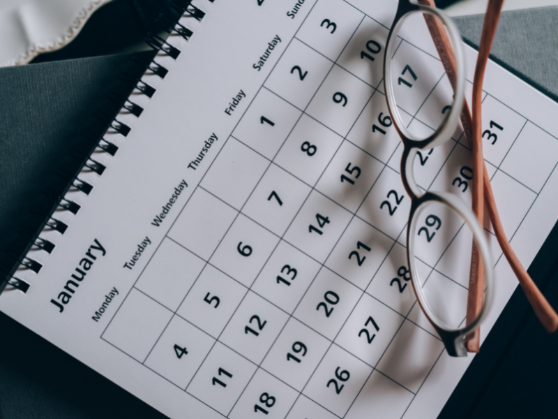 Brown framed eyeglasses on a calendar